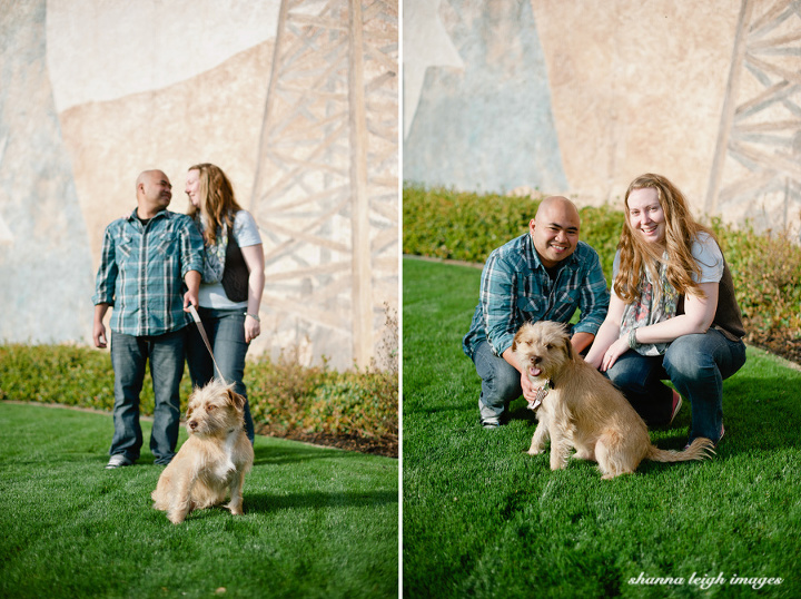 An engaged couple with their rescue dog in front of a Texas mural in Grapevine, Texas.