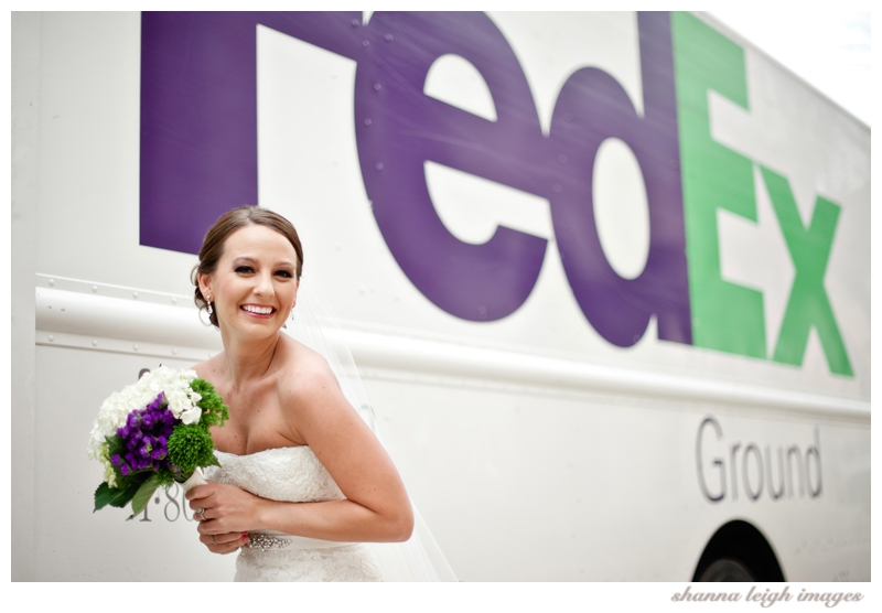 Jennifer being playful and posing for her bridal portraits on the streets of Colleville in front of a FedEx truck.