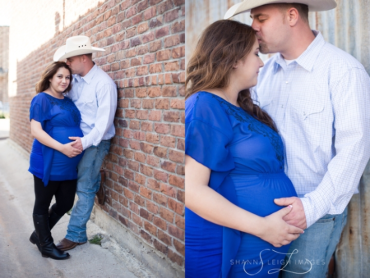 Lisa and Josh posing for maternity portraits in a brick alley in downtown Roanoke, Texas.