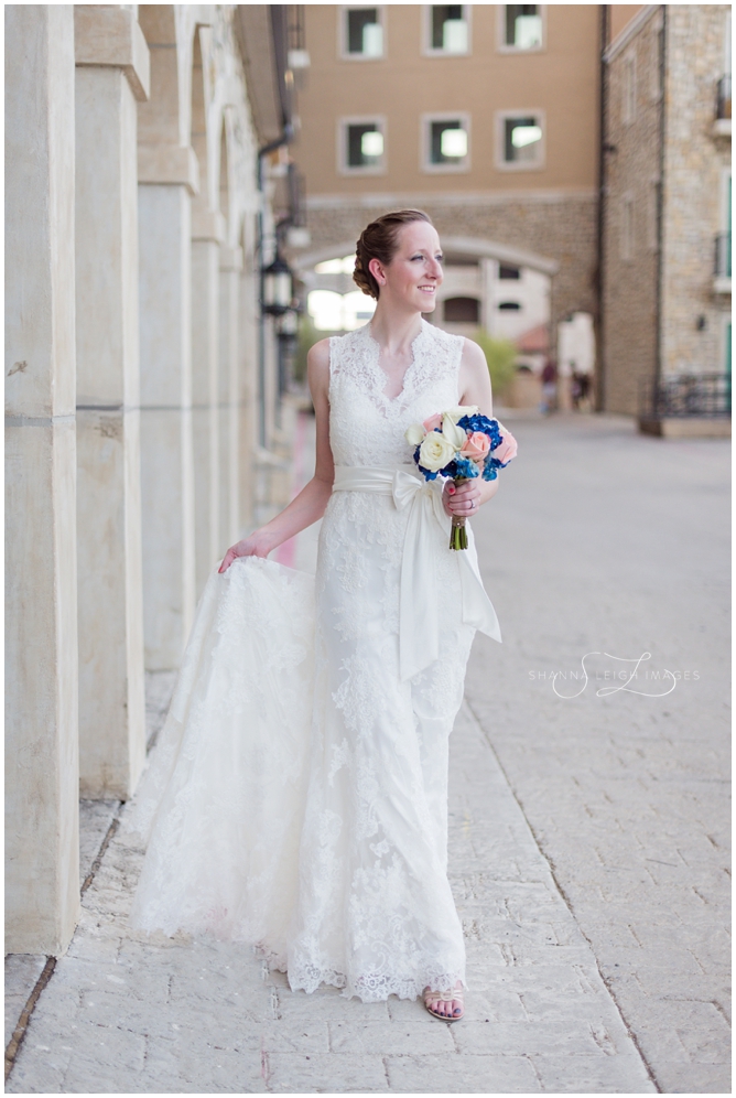 Stephanie in her lace Allure bridal gown posing for her bridal portraits at Adriatica in McKinney, Texas.
