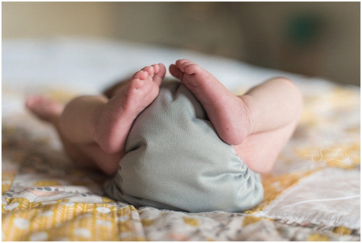 In home lifestyle newborn photography with a new family of four in Keller, Texas.