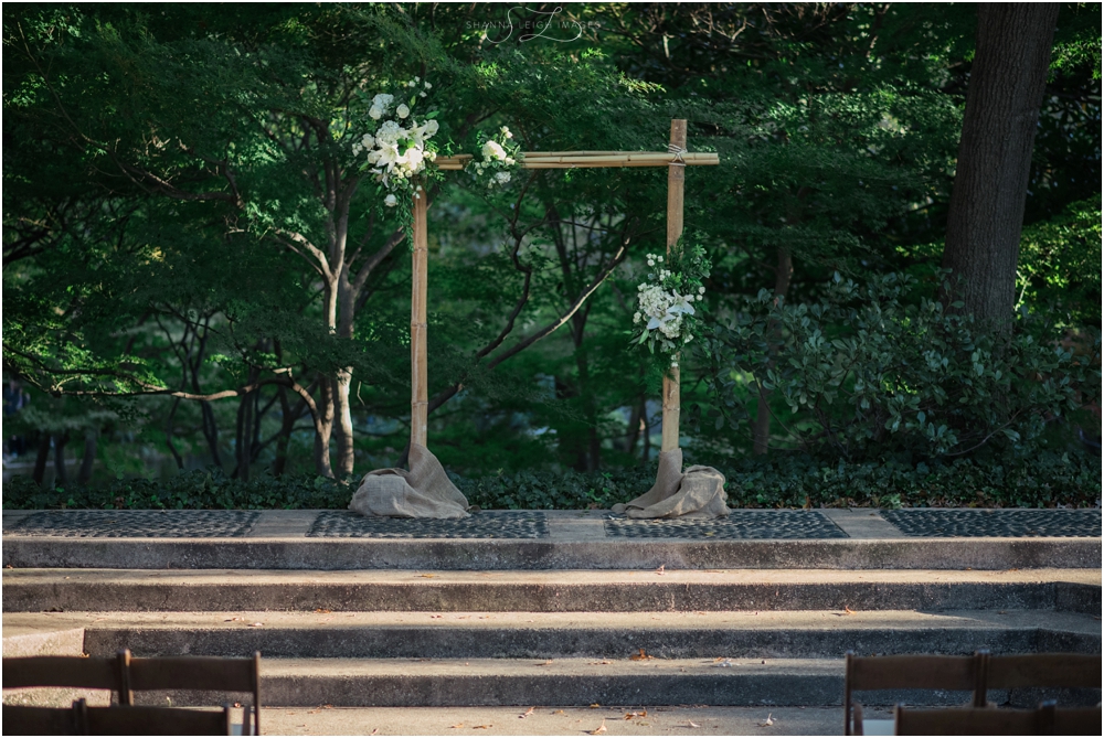 The gorgeous bamboo arbor decorated with orchids and succulents designed by Devin Designs for Rachel and Jason's gorgeous outdoor ceremony at the Japanese Gardens at the Fort Worth Botanical Gardens.