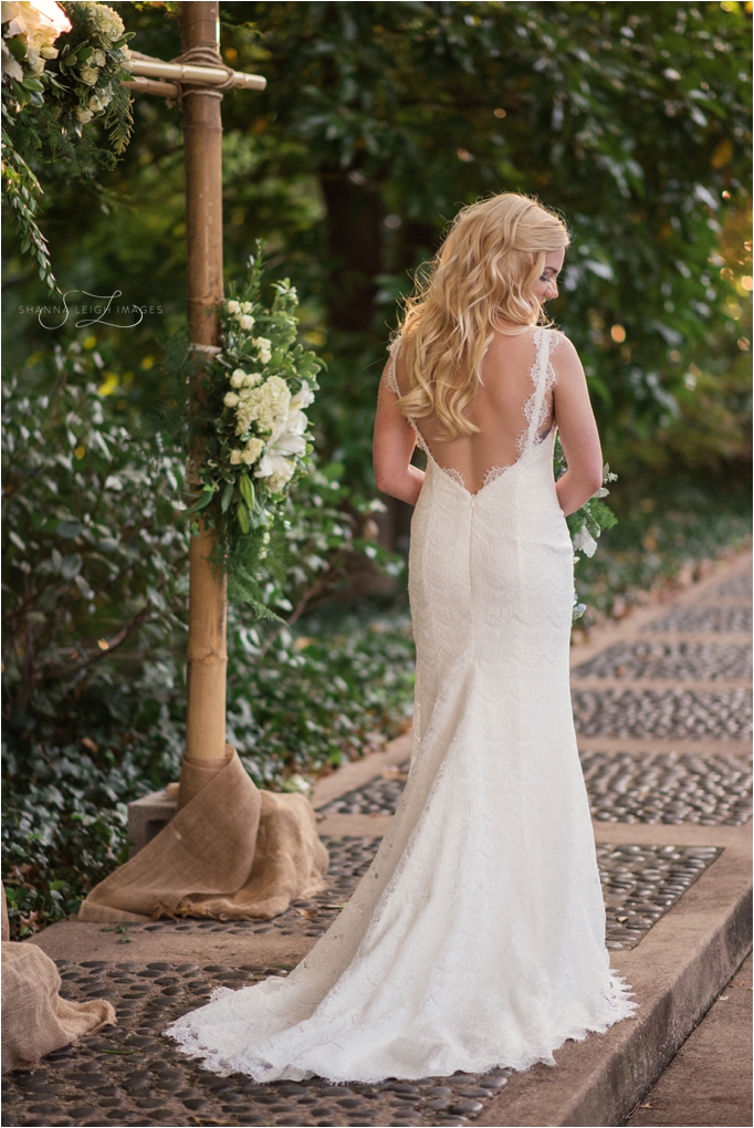 Rachel looked straight out of a fairy tale on her wedding day with her cascading loose blonde curls, her scalloped lace backless Robert Bullock bridal gown from Stardust Celebrations, and her navy blue Christian Louboutin pumps for her gorgeous outdoor wedding at the Japanese Gardens at the Fort Worth Botanical Gardens.