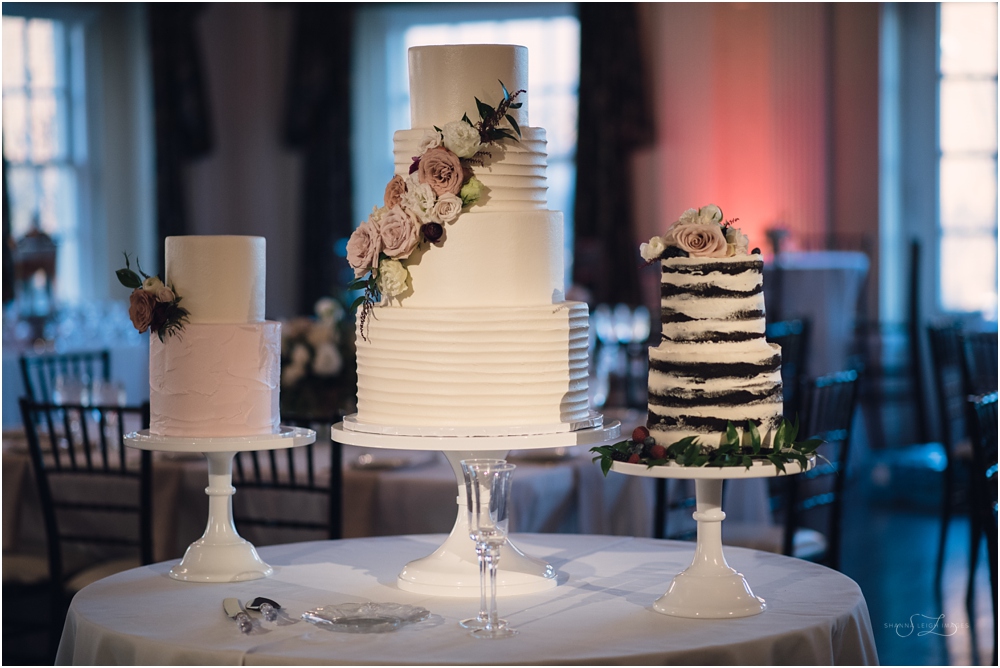 Gorgeous wedding cakes from Sugar Bee Sweets Bakery creatively displayed in the center of the reception.