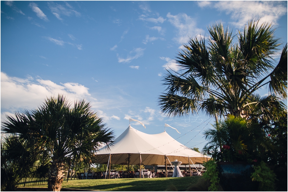 A gorgeous wedding under a big white pennant tent.
